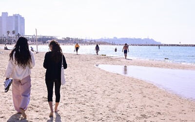 People walk along the beach in Tel Aviv during an unseasonably warm day on January 8, 2026. (Avshalom Sassoni/FLASH90) People walk along the beach in Tel Aviv during an unseasonably warm day on January 8, 2026. (Avshalom Sassoni/FLASH90)