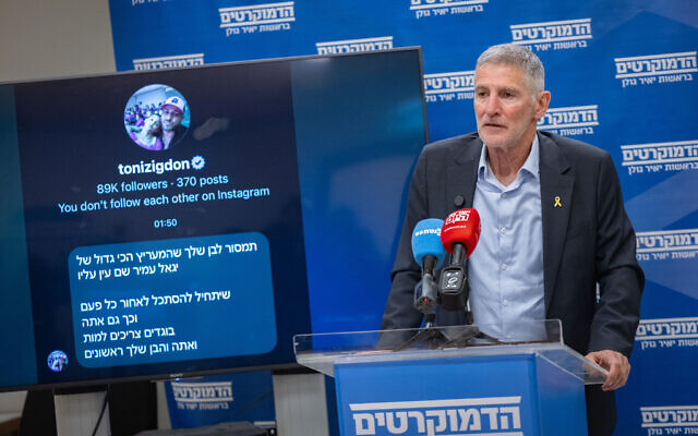 The Democrats leader Yair Golan displays a death threat that he said was sent to him and his son, during a faction meeting at the Knesset in Jerusalem, January 12, 2026. (Yonatan Sindel/Flash90)