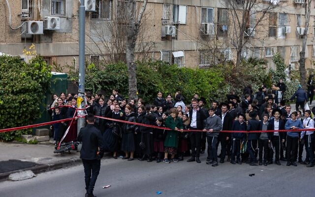 Bystanders at the scene of an incident at a Jerusalem daycare, January 19, 2026. (Chaim Goldberg/Flash90)