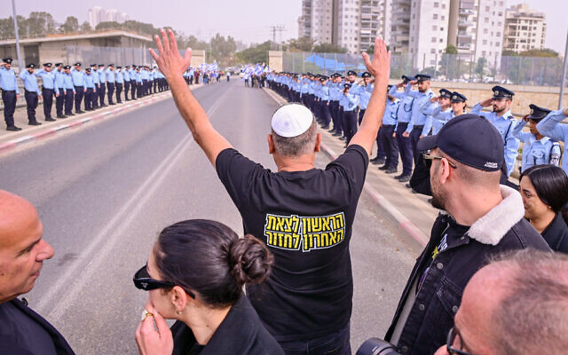 Itzik Gvili, the father of slain police officer Master Sgt. Ran Gvili, thanks the Israel Police officers stationed along the funeral procession route, on January 28, 2026. (Avshalom Sassoni/FLASH90)