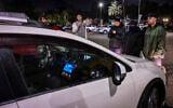 Far-right activist Mordechai David and other agitators block the vehicle of former Supreme Court president Aharon Barak, outside an event in Tel Aviv held by the Movement for Quality Government, January 28, 2026. (Avshalom Sassoni/Flash90)