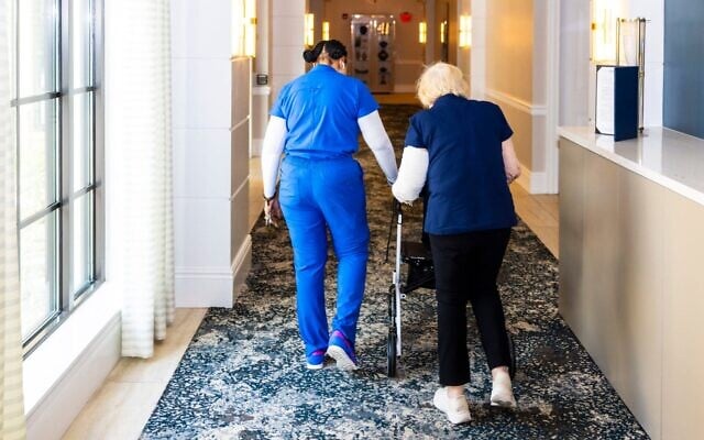 A staff member assists a resident of the Sinai Residences in Boca Raton, Florida, on June 6, 2025. (Saul Martinez for The Washington Post via Getty Images/JTA)