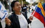 A woman holds Israeli and Venezuelan flags in front of the Venezuelan consulate in Miami to show solidarity with the Venezuelan Jewish community after an attack on a Caracas synagogue, February 13, 2009. (Joe Raedle/Getty Images via JTA)