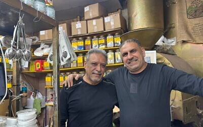 Iranian Jews, Bijan Barchorderi, a restaurant owner (left); and Isaac Simanian, a merchant, sell Persian specialties at the Levinsky Market in south Tel Aviv, January 22, 2026. (Sharon Wrobel/ The Times of Israel)