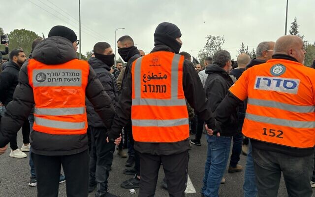 Municipal workers form human barrier between protesters and police during a march over police handling of violent crime in Sakhnin, northern Israel on January 22, 2026. (Charlie Summers/Times of Israel) Municipal workers form human barrier between protesters and police during a march over police handling of violent crime in Sakhnin, northern Israel on January 22, 2026. (Charlie Summers/Times of Israel)