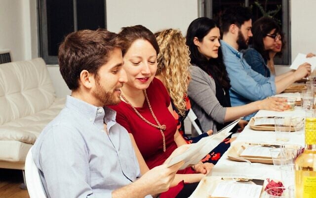 People gather for a OneTable Shabbat dinner. (Courtesy of OneTable via JTA)