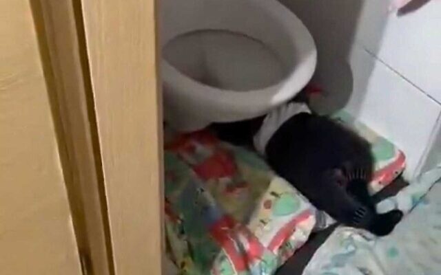 A toddler seen sleeping next to a toilet in an overcrowded unlicensed daycare in Jerusalem in which 2 babies died. (Social media screenshot used in accordance with clause 27a of the copyright law)