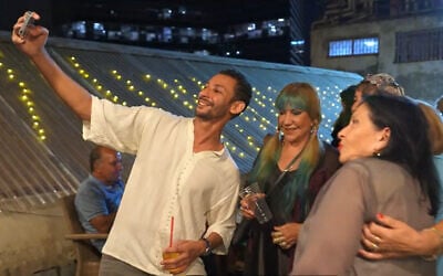 Yona Elfassi (L), founder of Limud Darija, with students at an event, in a video published on October 25, 2023. (YouTube screenshot/Limud Darija)