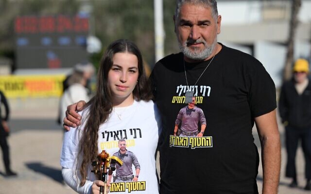 Former hostage Agam Berger, left, and Itzik Gvili, father of Ran Gvili, the remaining hostage body in Gaza, on January 16, 2026 at Tel Aviv's Hostages Square (Paulina Patimer/Hostages Forum)