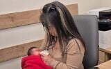 A National Insurance Institute worker feeds a baby found abandoned in a stairwell in Hadera, January 26, 2026. (National Insurance Institute spokesperson)