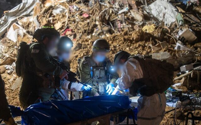 IDF troops operate at a cemetery in Gaza City during a search for the body of Master Sgt. Ran Gvili, in a handout photo issued on January 26, 2026. (Israel Defense Forces)
