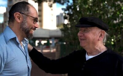Director Yoav Potash (left) greets Yaacov Goldstein, one of the last Jewish survivors of Gniewoszów, Poland. (Courtesy of 8 Above via JTA)