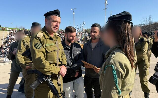 L-R: Chief Armored Officer Brig. Gen. Ohad Maor, and former hostages Matan Angrest and Nimrod Cohen, are seen duriing a military ceremony at Yad Lashiryon, the Armored Corps Memorial Site and Museum, February 20, 2026. (Israel Defense Forces) L-R: Chief Armored Officer Brig. Gen. Ohad Maor, and former hostages Matan Angrest and Nimrod Cohen, are seen duriing a military ceremony at Yad Lashiryon, the Armored Corps Memorial Site and Museum, February 20, 2026. (Israel Defense Forces)