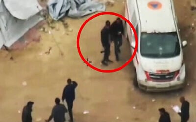 A screenshot from a video published by the IDF on February 4, 2026, shows gunmen, who the military says are Hamas operatives, operating around an ambulance in northern Gaza's Jabalia. (Israel Defense Forces)
