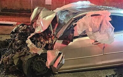 The remains of a car that collided with a bus after the occupants were shot amid a feud between warring crime families, February 3, 2026. (Magen David Adom)