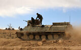 Fighters from the Syrian Democratic Forces (SDF) sit atop an armoured personnel carrier on the outskirts of the town of al-Shadadi in the northeastern Syrian province of Hasakeh, on February 19, 2016. (Delil souleiman / AFP)