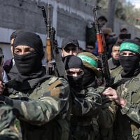 Masked Hamas gunmen attend the funeral of Mahmoud al-Nabaheen, 24, in the Bureij refugee camp, in the central Gaza Strip, on January 23, 2019. (MAHMUD HAMS / AFP) Masked Hamas gunmen attend the funeral of Mahmoud al-Nabaheen, 24, in the Bureij refugee camp, in the central Gaza Strip, on January 23, 2019. (MAHMUD HAMS / AFP)