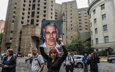 A protester holds up a photo of Jeffrey Epstein in front of the Metropolitan Correction Center on July 8, 2019, in New York City. (Stephanie Keith/Getty Images/AFP)