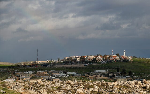 Palestinian Bedouin houses are pictured in front of the Israeli settlement of Adam, between Jerusalem and Ramallah in the West Bank, on March 4, 2021. (Photo by AHMAD GHARABLI / AFP) Palestinian Bedouin houses are pictured in front of the Israeli settlement of Adam, between Jerusalem and Ramallah in the West Bank, on March 4, 2021. (Photo by AHMAD GHARABLI / AFP)