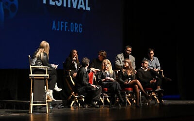 From left to right: Meghan Leathers, Jon Bass, Theo Taplitz, Kyra Sedgwick, Method Man, Milana Vayntrub, Adam Mitchell, and Daniel Robbins speak onstage during the 25th Atlanta Jewish Film Festival 'Bad Shabbos' opening night premiere at Cobb Energy Performing Arts Center on February 19, 2025, in Atlanta, Georgia. (Derek White/ AFP)