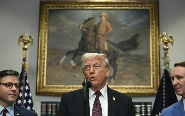 US President Donald Trump, flanked by Speaker of the House Mike Johnson (L) and Louisiana Governor Jeff Landry (R), speaks in the Roosevelt Room of the White House in Washington, DC, March 24, 2025. (Brendan SMIALOWSKI / AFP)
