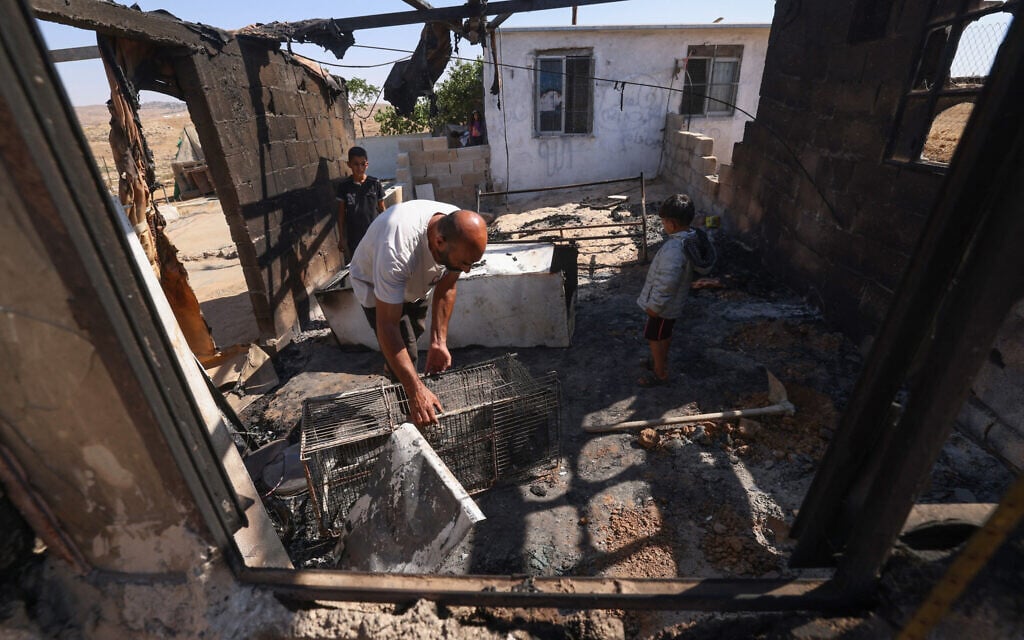 Nasser Ishreiteh and his children clear burnt belongings in the living and kitchen area of their house after an apparent attack overnight by Israelis from a nearby settlement, in Susya south of Hebron in the West Bank on February 25, 2025 (HAZEM BADER / AFP) Nasser Ishreiteh and his children clear burnt belongings in the living and kitchen area of their house after an apparent attack overnight by Israelis from a nearby settlement, in Susya south of Hebron in the West Bank on February 25, 2025 (HAZEM BADER / AFP)