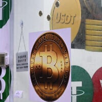 Illustrative: The symbols of bitcoin and the stablecoin Tether (USDT) are displayed at a cryptocurrency store in Hong Kong on July 29, 2025. (Peter PARKS / AFP)