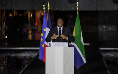 South Africa's Minister of Sports, Arts and Culture Gayton McKenzie (C) speaks as he attends a commemoration ceremony, for French individuals who fought against apartheid, with South Africa's Deputy President Paul Mashatile and Frances President Emmanuel Macron at Freedom Park in Pretoria on November 21, 2025 ahead of the G20 leaders' Summit. (Photo by Ludovic MARIN / AFP)
