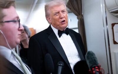 US President Donald Trump speaks to members of the media aboard Air Force One as he travels from Washington, DC, to West Palm Beach, Florida, on January 31, 2026. (SAUL LOEB / AFP)