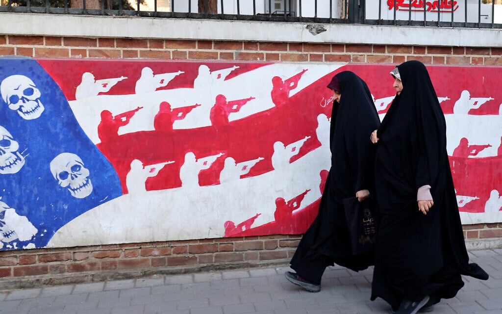 Women walk past a mural painted on the outer walls of the former US embassy in Tehran on February 1, 2026 (ATTA KENARE / AFP) Women walk past a mural painted on the outer walls of the former US embassy in Tehran on February 1, 2026 (ATTA KENARE / AFP)