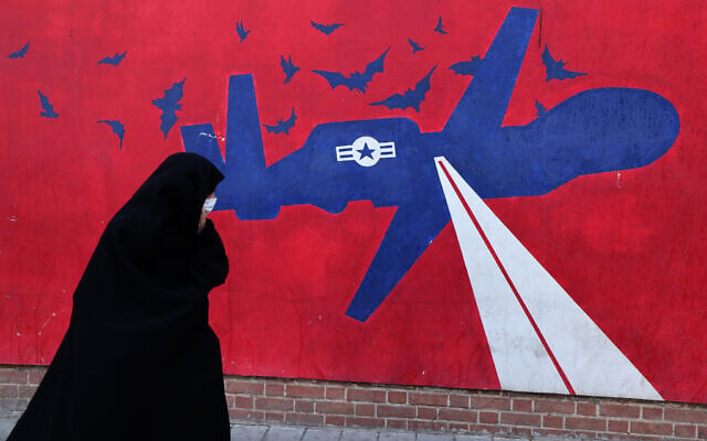 A woman walks past a mural depicting a US drone painted on the outer walls of the former US embassy in Tehran, colloquially-referred to as the "Spy Den,"on February 1, 2026. (ATTA KENARE / AFP) A woman walks past a mural depicting a US drone painted on the outer walls of the former US embassy in Tehran, colloquially-referred to as the "Spy Den,"on February 1, 2026. (ATTA KENARE / AFP)