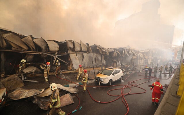 Smoke rises as firefighters battle a fire that broke out in Jannat Bazaar, in the western Tehran area, on February 3, 2026. (ATTA KENARE / AFP) Smoke rises as firefighters battle a fire that broke out in Jannat Bazaar, in the western Tehran area, on February 3, 2026. (ATTA KENARE / AFP)