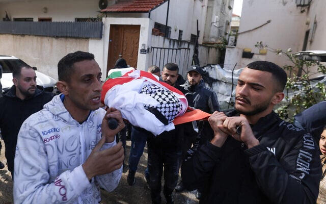 Palestinians carry the body of twenty-one-year-old Omer Al-Swarki during his funeral in the West Bank city of Qalqilya on February 3, 2026 after he was killed while trying to cross the separation wall between Qalqilya and Israel in order to work inside Israel. (Photo by JAAFAR ASHTIYEH / AFP) Palestinians carry the body of twenty-one-year-old Omer Al-Swarki during his funeral in the West Bank city of Qalqilya on February 3, 2026 after he was killed while trying to cross the separation wall between Qalqilya and Israel in order to work inside Israel. (Photo by JAAFAR ASHTIYEH / AFP)