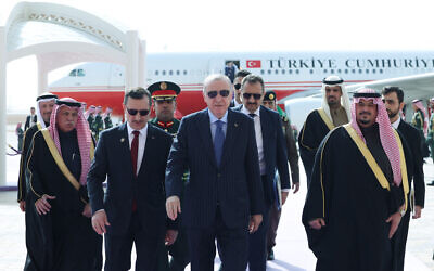 Turkey's President Recep Tayyip Erdogan (C) walks with Saudi officials upon his arrival in Riyadh on February 3, 2026. (TURKISH PRESIDENCY PRESS OFFICE / AFP)