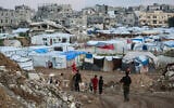 Children walk past tents and makeshift shelters in the Bureij refugee camp in the central Gaza Strip on February 3, 2026. (Eyad BABA / AFP)