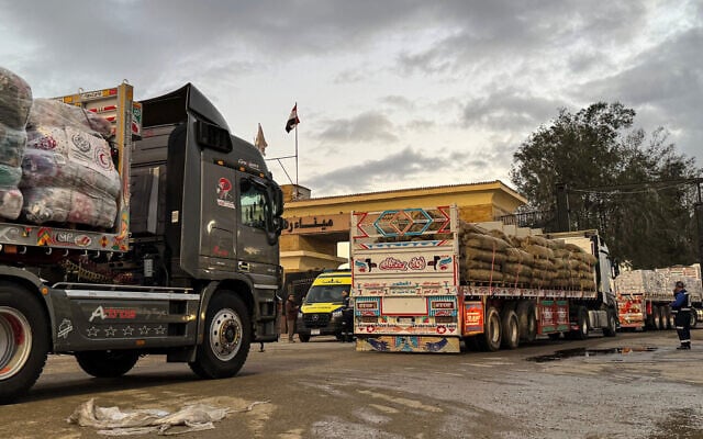 Humanitarian aid trucks enter through the Egyptian side of the Rafah border crossing with the Gaza Strip on February 4, 2026, days after Israel permitted a limited reopening of the border post. (AFP)