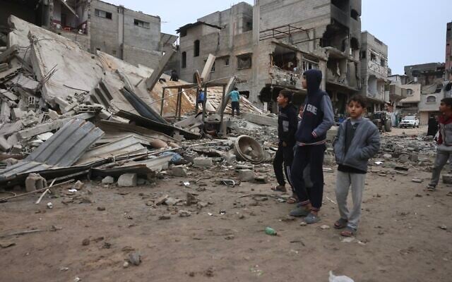 Displaced Palestinians inspect the damage after Israeli aircraft targeted a five floor house last night, in Khan Yunis southern Gaza Strip on February 6, 2026. (Bashar Taleb/AFP)