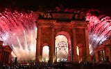 Fireworks and the Olympic flame are during the opening ceremony of the Milano Cortina 2026 Winter Olympic Games next to the Arco della Pace monument in Milan, northern Italy, on February 6, 2026. (Daniel MUNOZ / AFP)