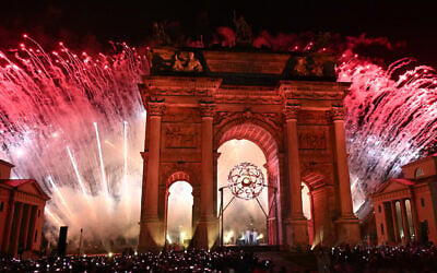 Fireworks and the Olympic flame are during the opening ceremony of the Milano Cortina 2026 Winter Olympic Games next to the Arco della Pace monument in Milan, northern Italy, on February 6, 2026. (Daniel MUNOZ / AFP)