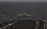 In this handout photograph released by the US Navy on February 5, 2026, an F/A-18E Super Hornet, attached to Strike Fighter Squadron (VFA) 14, launches from the flight deck of Nimitz-class aircraft carrier USS Abraham Lincoln in the Arabian Sea on February 3, 2026. (Zoe Simpson/US Navy/AFP)