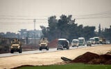US military vehicles move along a road in a convoy transporting Islamic State group detainees being transferred to Iraq from Syria, on the outskirts of Qahtaniyah in Syria's northeastern Hasakah province on February 7, 2026. (Delil SOULEIMAN / AFP)