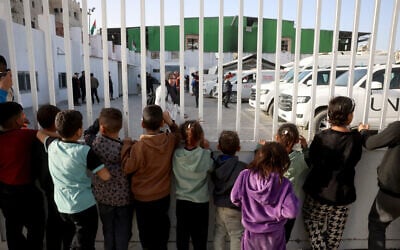 Palestinian children watch as patients prepare to leave the Gaza Strip for treatment through the Rafah border crossing between the Gaza Strip and Egypt after it was opened by Israel for a limited number of people, in Khan Younis in the southern Gaza Strip, on February 8, 2026. (Bashar Taleb/ AFP) Palestinian children watch as patients prepare to leave the Gaza Strip for treatment through the Rafah border crossing between the Gaza Strip and Egypt after it was opened by Israel for a limited number of people, in Khan Younis in the southern Gaza Strip, on February 8, 2026. (Bashar Taleb/ AFP)