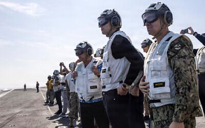 US Special Envoy for Peace Missions Steve Witkoff (L), Jared Kushner (C) and US Navy Admiral Brad Cooper, commander of US Central Command (R), as they observe flight operations aboard Nimitz-class aircraft carrier USS Abraham Lincoln (CVN 72) in the Arabian Sea on February 7, 2026. (US Navy via AFP)