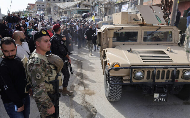Lebanese army vehicles secure the street as residents gather during a visit by Lebanon's prime minister to the southern village of Kfar Kila on February 8, 2026. (Photo by Rabih DAHER / AFP) Lebanese army vehicles secure the street as residents gather during a visit by Lebanon's prime minister to the southern village of Kfar Kila on February 8, 2026. (Photo by Rabih DAHER / AFP)