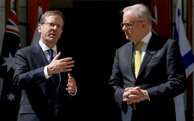 Australia's Prime Minister Anthony Albanese (R) receives President Isaac Herzog at the Parliament House in Canberra on February 11, 2026. (Photo by DAVID GRAY / AFP)