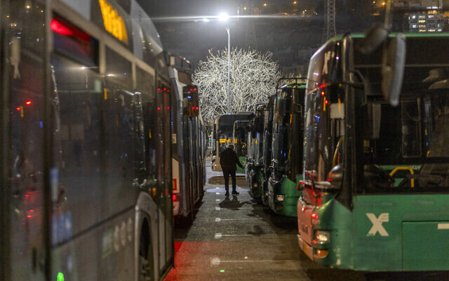 A bus driver walks to his vehicle outside Teddy Stadium during a game night for the Beitar Jerusalem soccer team in the Malha neighborhood of Jerusalem on January 31, 2026. (Ilia YEFIMOVICH / AFP) A bus driver walks to his vehicle outside Teddy Stadium during a game night for the Beitar Jerusalem soccer team in the Malha neighborhood of Jerusalem on January 31, 2026. (Ilia YEFIMOVICH / AFP)