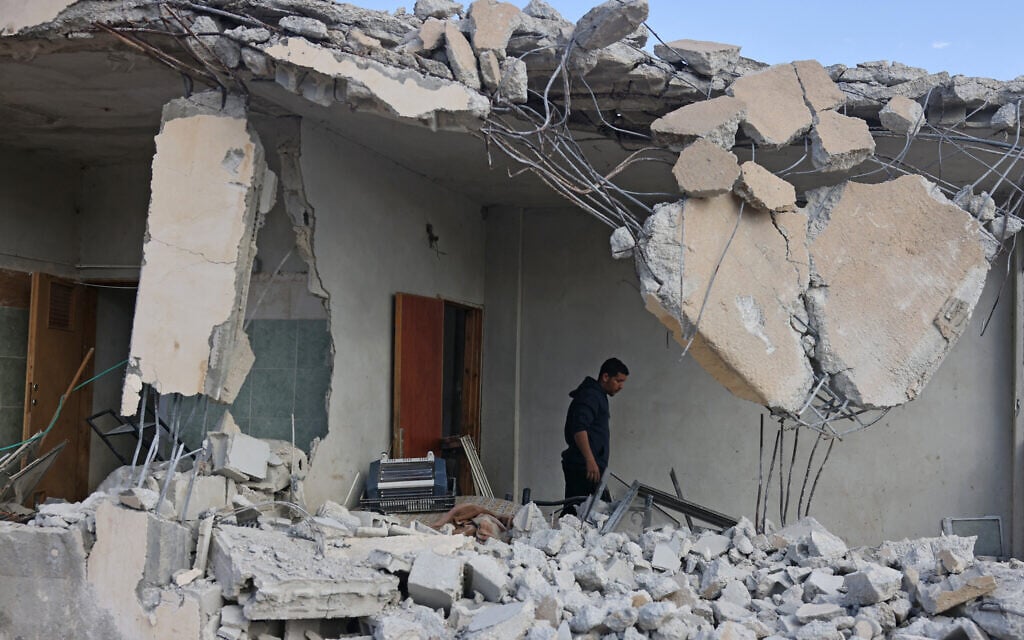 A Palestinian man stands in a house that was reportedly demolished by Israeli settlers the previous day in the village of Al-Duyuk Al-Tahta on the outskirts of Jericho, in the West Bank, on February 11, 2026. (AHMAD GHARABLI / AFP)