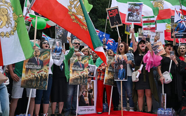 Members of the Iranian community wave flags as they march during a rally in Sydney on February 14, 2026, calling for stronger international action and urging the United States to intervene against the current Iranian regime. (Photo by Saeed KHAN / AFP) Members of the Iranian community wave flags as they march during a rally in Sydney on February 14, 2026, calling for stronger international action and urging the United States to intervene against the current Iranian regime. (Photo by Saeed KHAN / AFP)