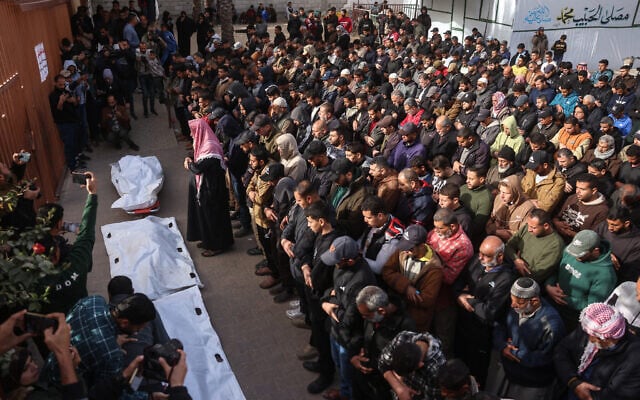 Palestinians mourners gather during a funeral to pray over the bodies of several killed in an overnight Israeli strike, Nasser Hospital in Khan Younis, southern Gaza, February 15, 2026. (Bashar Taleb / AFP)
