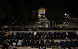 Palestinian Muslim worshipers perform Taraweeh prayers on the first night of the Muslim holy month of Ramadan near the Dome of the Rock Shrine at the Al-Aqsa mosque compound atop the Temple Mount, in the Old City of Jerusalem on February 17, 2026. (AHMAD GHARABLI / AFP)